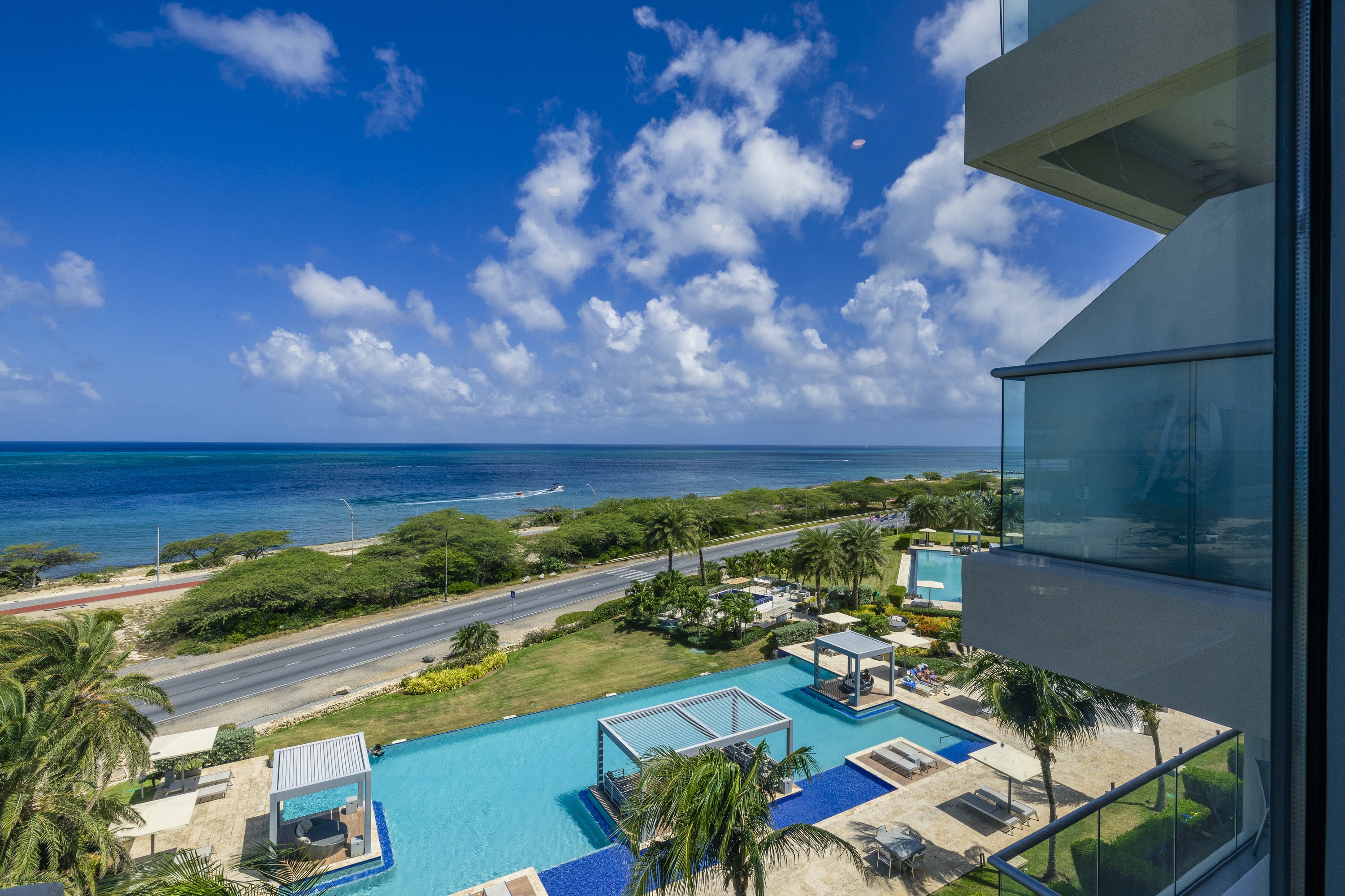 Ocean view from an Aruba Ocean Views residence balcony, pools and the Caribbean beyond